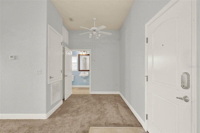 interior space with ceiling fan