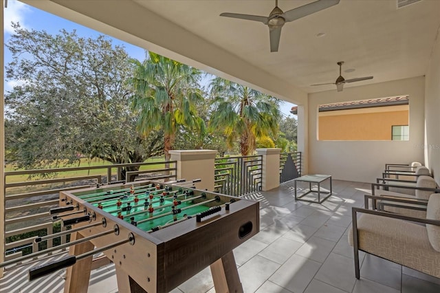 rec room with tile patterned floors and ceiling fan