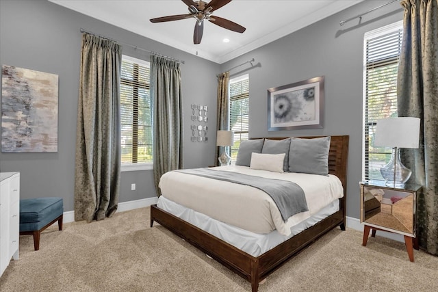 carpeted bedroom with ceiling fan and ornamental molding