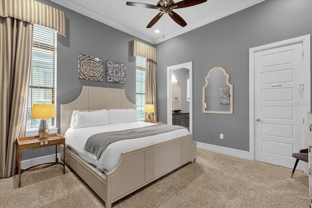 bedroom featuring multiple windows, carpet, ensuite bath, and ceiling fan