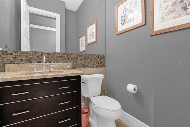 bathroom featuring decorative backsplash, vanity, and toilet