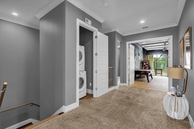 hall featuring stacked washer / dryer, carpet floors, and ornamental molding