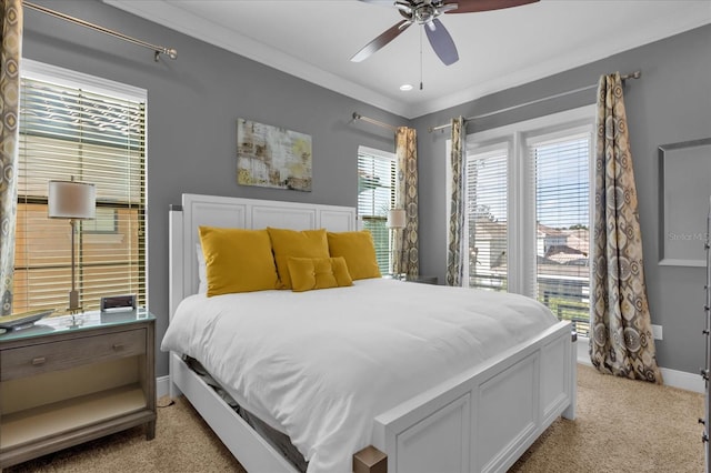 carpeted bedroom with ceiling fan and crown molding