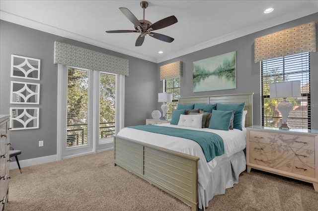 bedroom with multiple windows, carpet flooring, ceiling fan, and crown molding