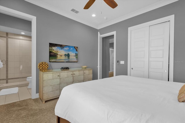 carpeted bedroom with ceiling fan, a closet, ornamental molding, and ensuite bath