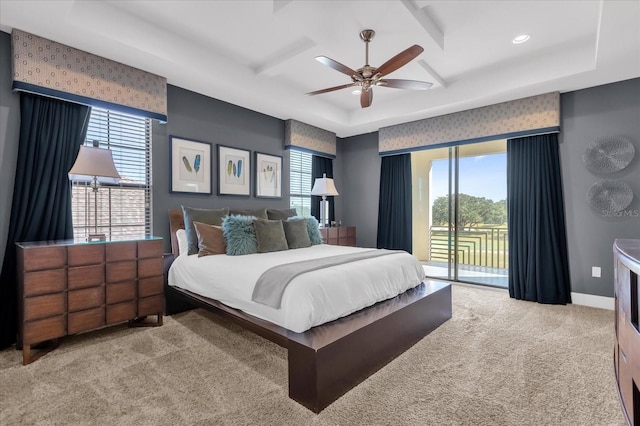 bedroom featuring access to outside, ceiling fan, a tray ceiling, and light colored carpet