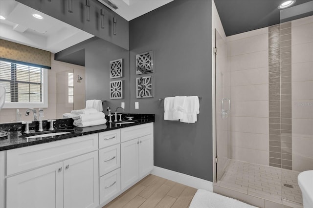 bathroom featuring vanity, wood-type flooring, and an enclosed shower