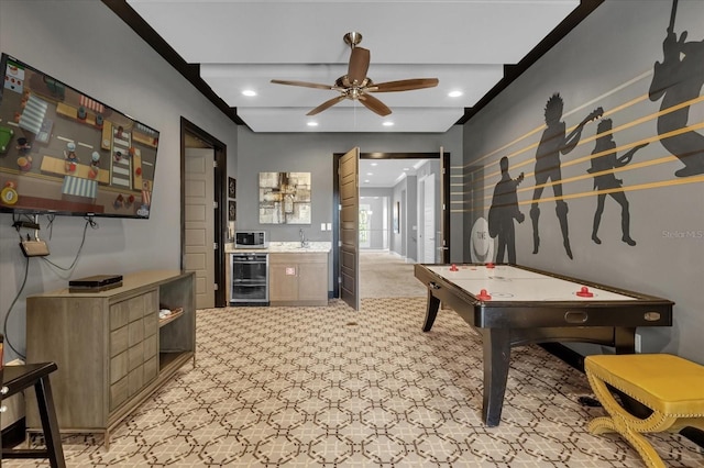 playroom with ceiling fan, sink, and beverage cooler