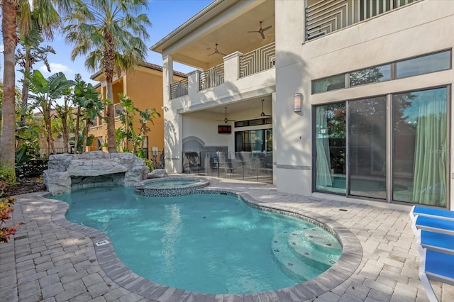 view of pool with ceiling fan, a patio area, and an in ground hot tub