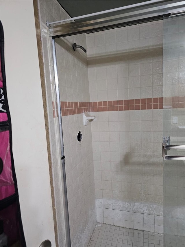 bathroom with a shower with door