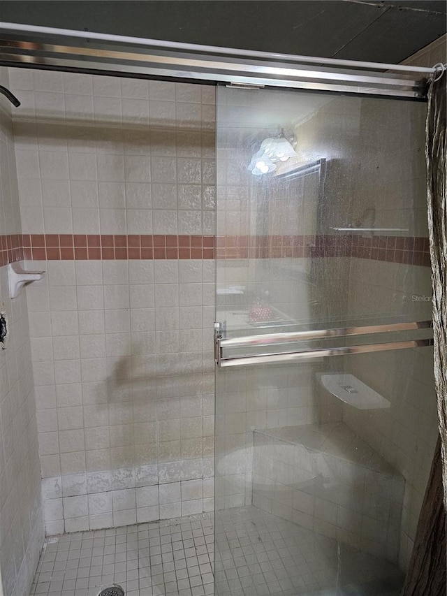 bathroom with a shower with shower door