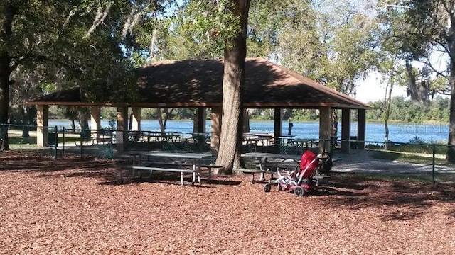 surrounding community with a gazebo and a water view