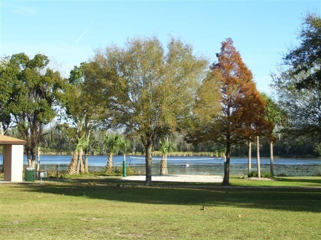 view of community featuring a water view and a yard