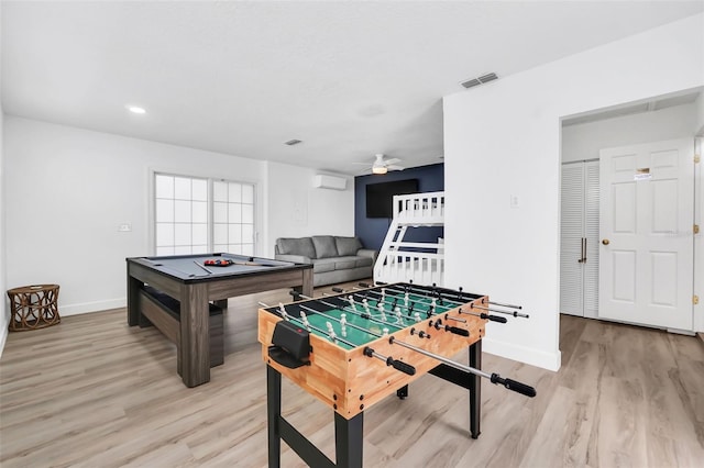 game room with ceiling fan, pool table, a wall mounted air conditioner, and light wood-type flooring