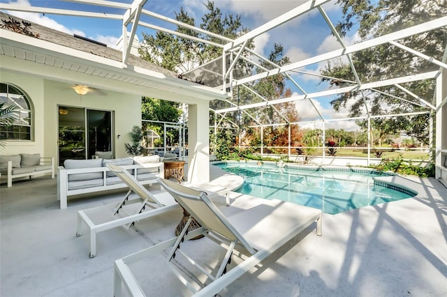 view of pool featuring a patio area, outdoor lounge area, and glass enclosure