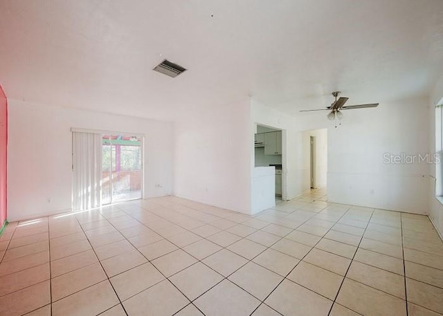 spare room with light tile patterned flooring and ceiling fan