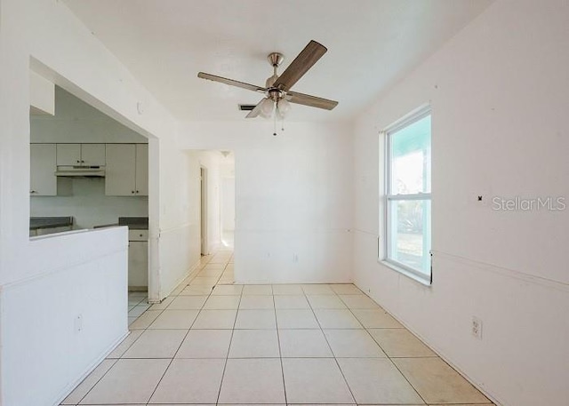 tiled empty room with ceiling fan