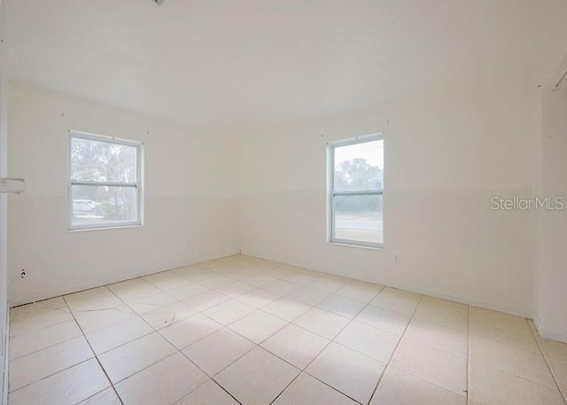 tiled empty room with a healthy amount of sunlight