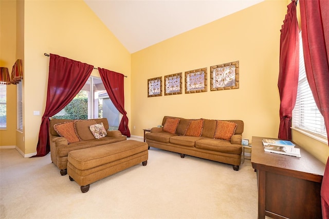 living room featuring plenty of natural light, carpet floors, and high vaulted ceiling