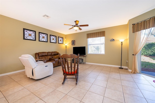 living room with ceiling fan and light tile patterned flooring