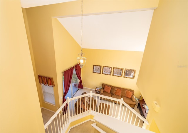 stairway with carpet flooring and a high ceiling