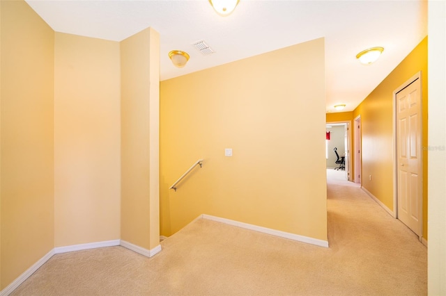 hall featuring light colored carpet