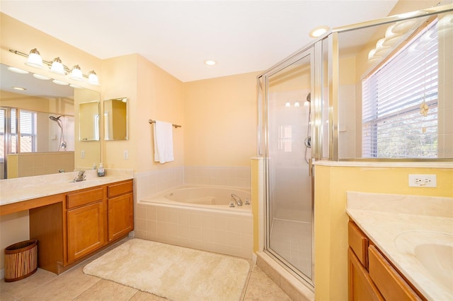 bathroom featuring tile patterned floors, vanity, and shower with separate bathtub