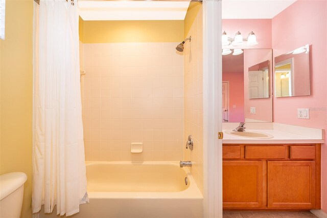 full bathroom with vanity, toilet, and shower / tub combo with curtain