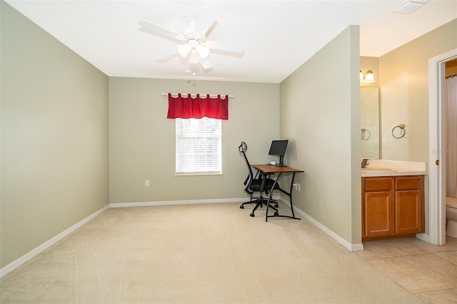 office space with ceiling fan, sink, and light carpet