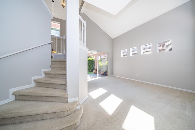 11313 Via Andiamo, Windermere, FL 34786 - stairway with healthy amount of natural light, high vaulted ceiling, and carpet flooring