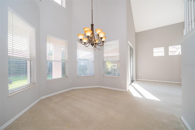 11313 Via Andiamo, Windermere, FL 34786 - spare room with a chandelier, light carpet, a high ceiling, and plenty of natural light