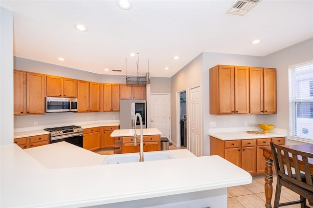 11313 Via Andiamo, Windermere, FL 34786 - kitchen featuring stainless steel appliances, light countertops, a center island with sink, light tile patterned floors, and recessed lighting