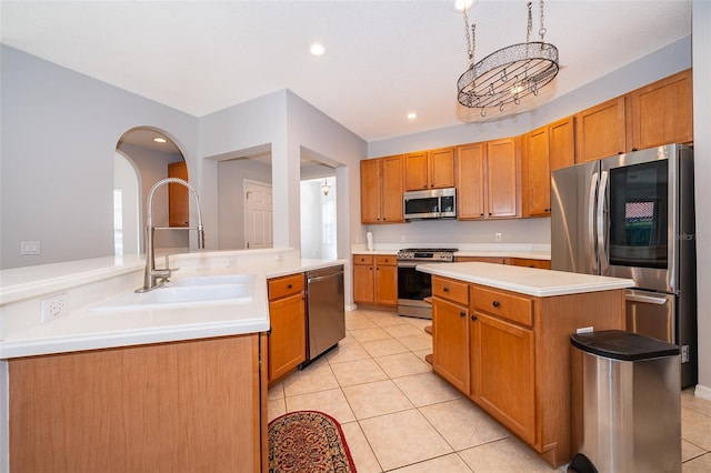 11313 Via Andiamo, Windermere, FL 34786 - kitchen with stainless steel appliances, a center island, light tile patterned flooring, light countertops, and recessed lighting