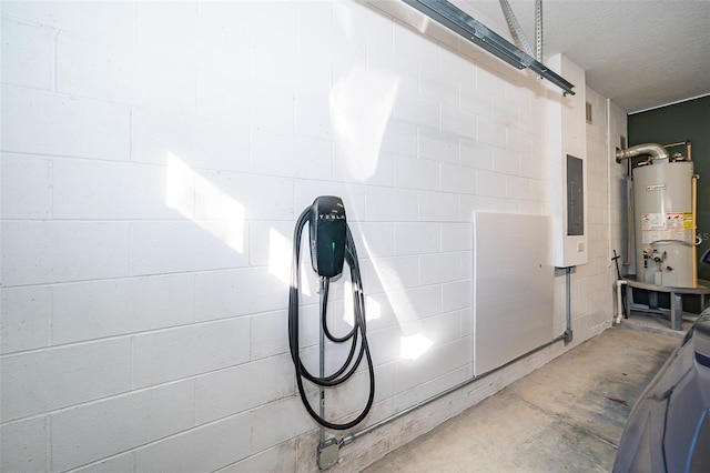 11313 Via Andiamo, Windermere, FL 34786 - garage view of water heater, concrete flooring, a textured ceiling, a barn door, and electric panel