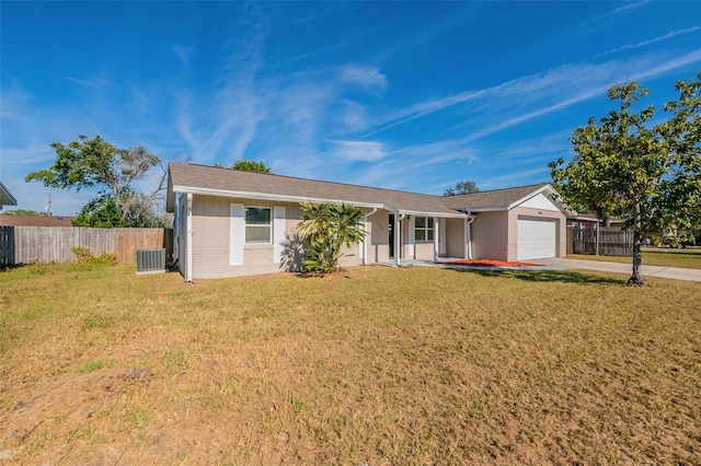 ranch-style home with a front yard, a garage, and central AC unit