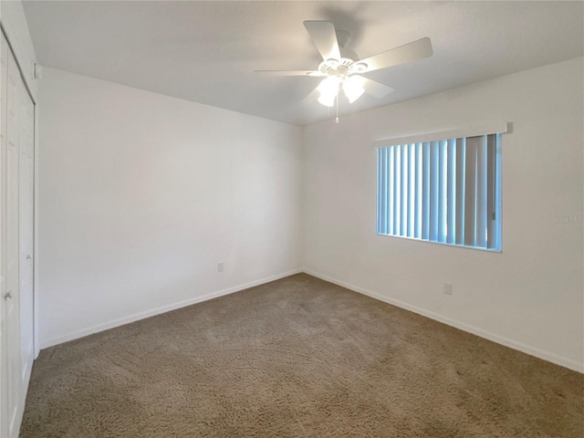 unfurnished room with ceiling fan and carpet floors