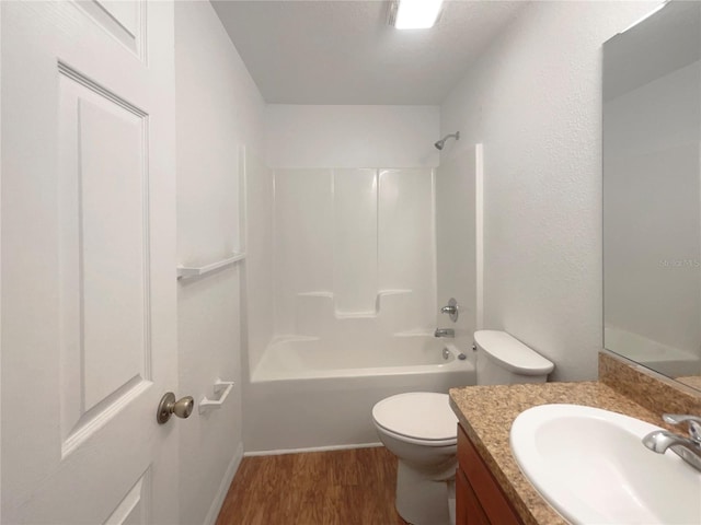 full bathroom featuring hardwood / wood-style flooring, vanity, toilet, and bathtub / shower combination