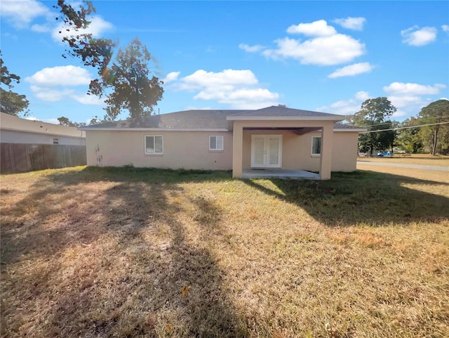 back of property featuring french doors, a yard, and a patio area