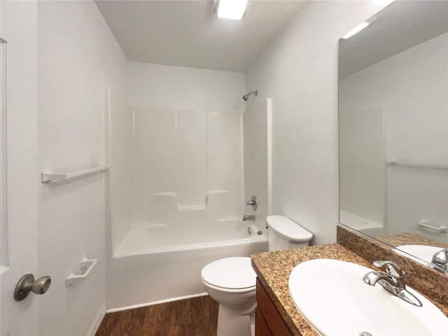 full bathroom with vanity,  shower combination, hardwood / wood-style flooring, and toilet