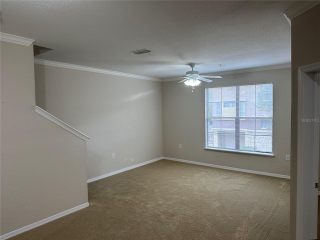 spare room featuring carpet flooring, ceiling fan, and ornamental molding