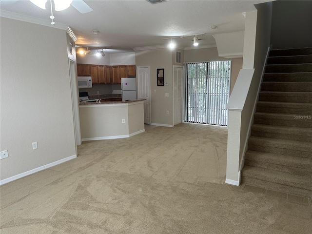 unfurnished living room featuring ceiling fan, crown molding, light carpet, and track lighting