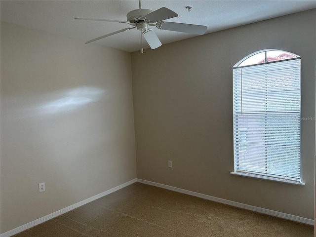 carpeted empty room with ceiling fan