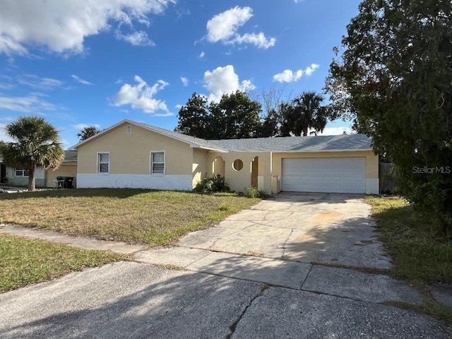 single story home featuring a garage and a front yard