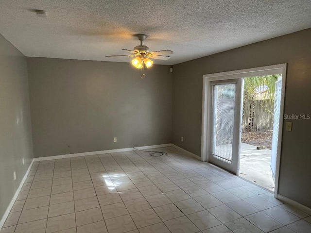 empty room featuring light tile patterned floors, a textured ceiling, and ceiling fan