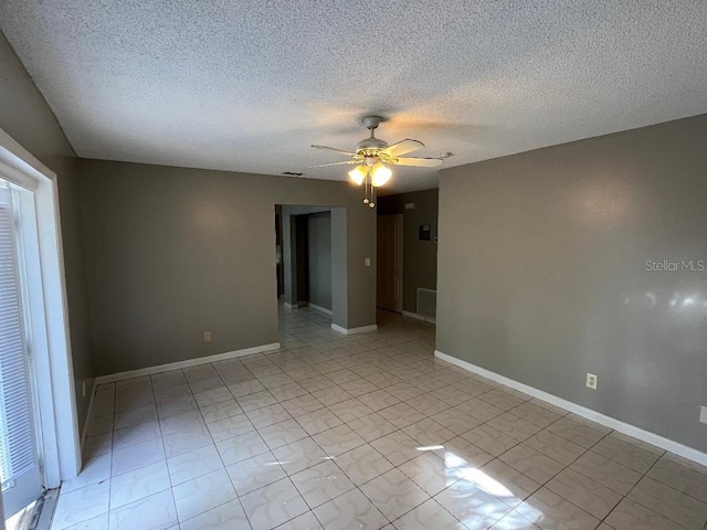 unfurnished room with a textured ceiling and ceiling fan