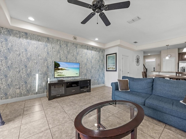 living room with ceiling fan and light tile patterned floors