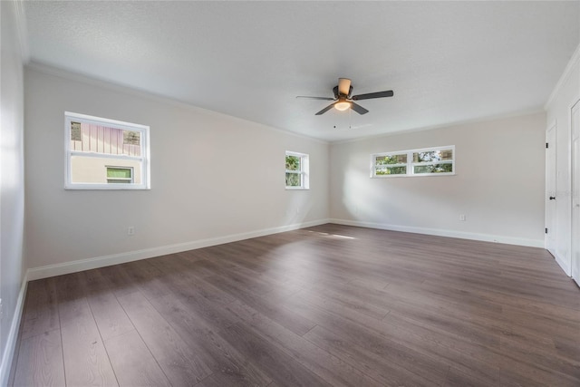 spare room with plenty of natural light, dark hardwood / wood-style floors, and ornamental molding