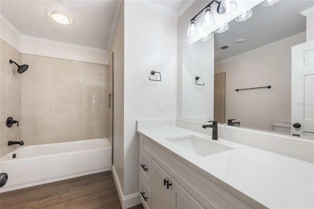 full bathroom with wood-type flooring, a textured ceiling, toilet, and ornamental molding