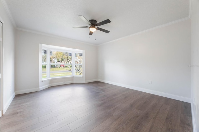 spare room with hardwood / wood-style floors, ceiling fan, and crown molding