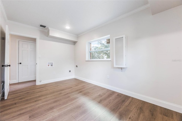 spare room featuring hardwood / wood-style floors and crown molding